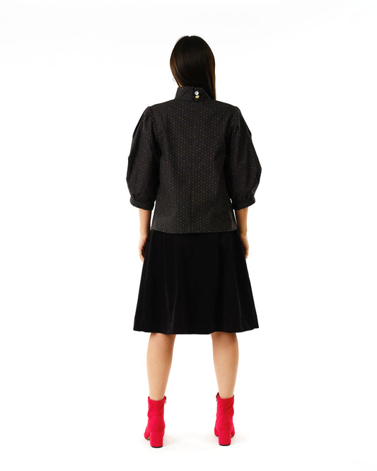 Jennifer Glasgow Design polka dot puff sleeve blouse back view with black skirt and pink ankle boots in Kelowna