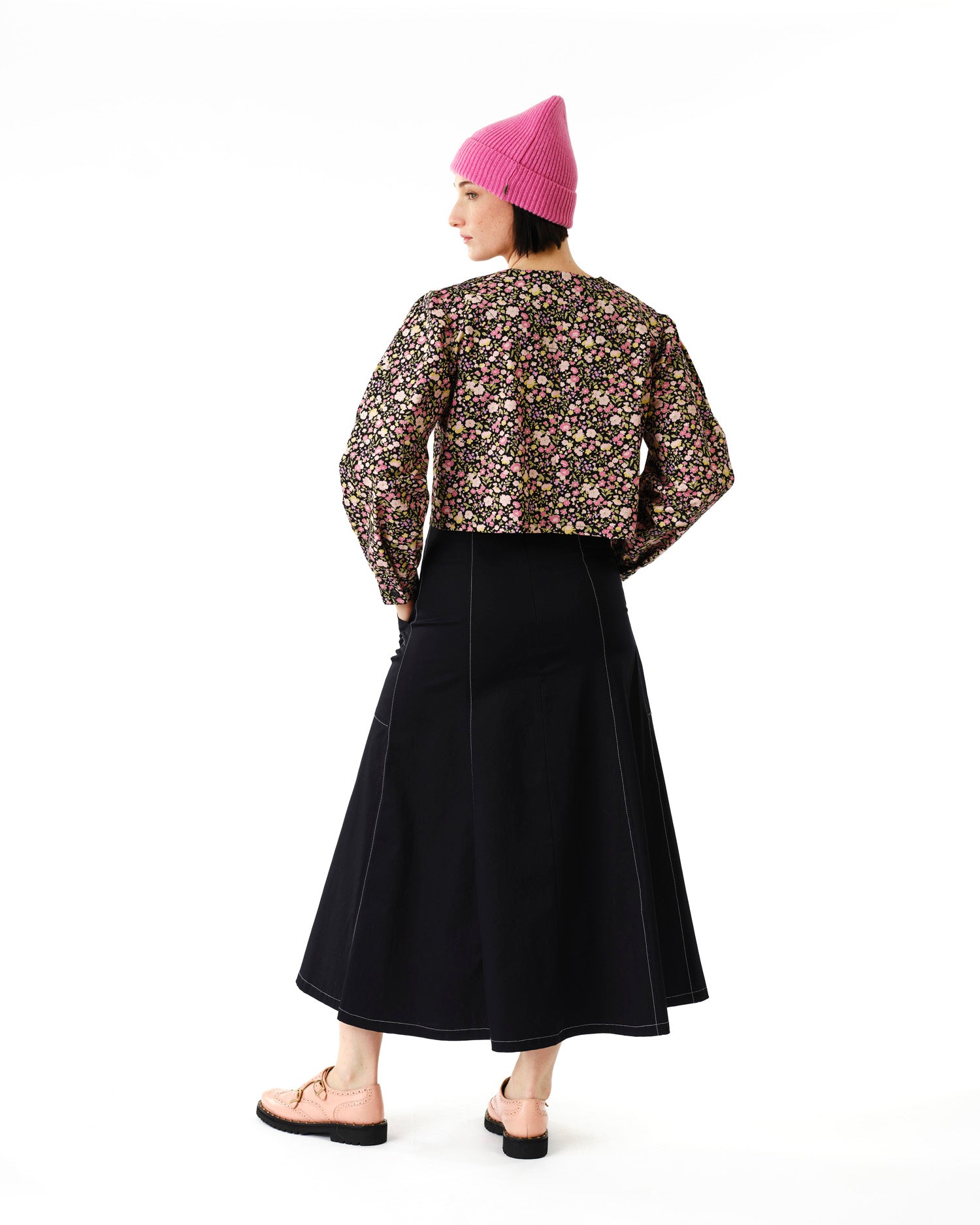 Jennifer Glasgow Design model wearing cropped floral jacket with black A line midi skirt and pink beanie in Kelowna