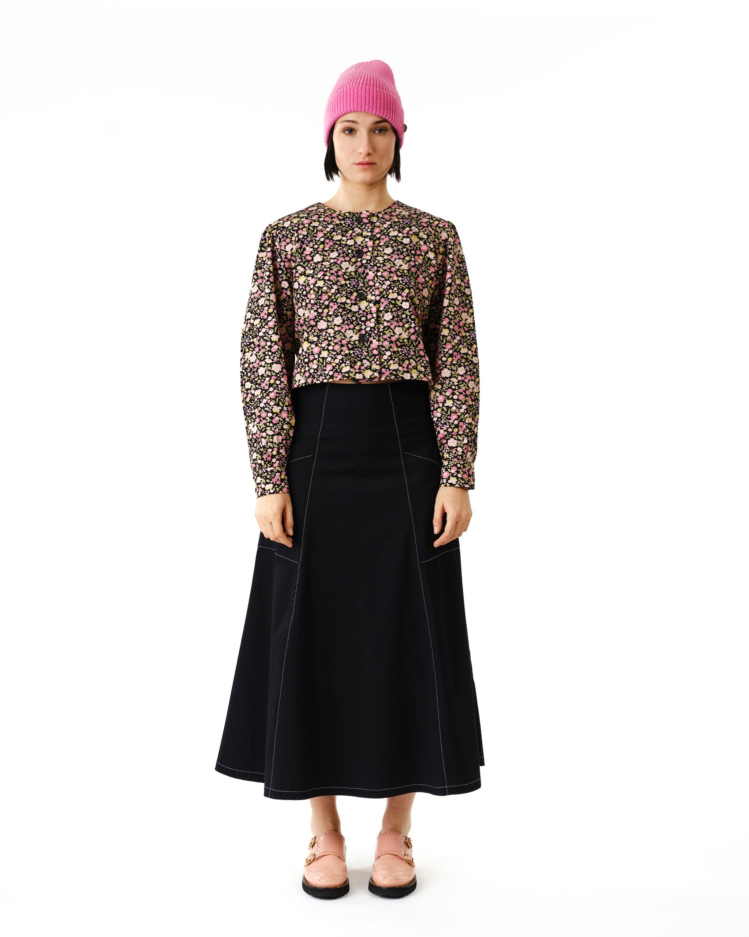 Jennifer Glasgow Design model wearing floral cropped jacket pink beanie black A line skirt and pink sandals in Kelowna