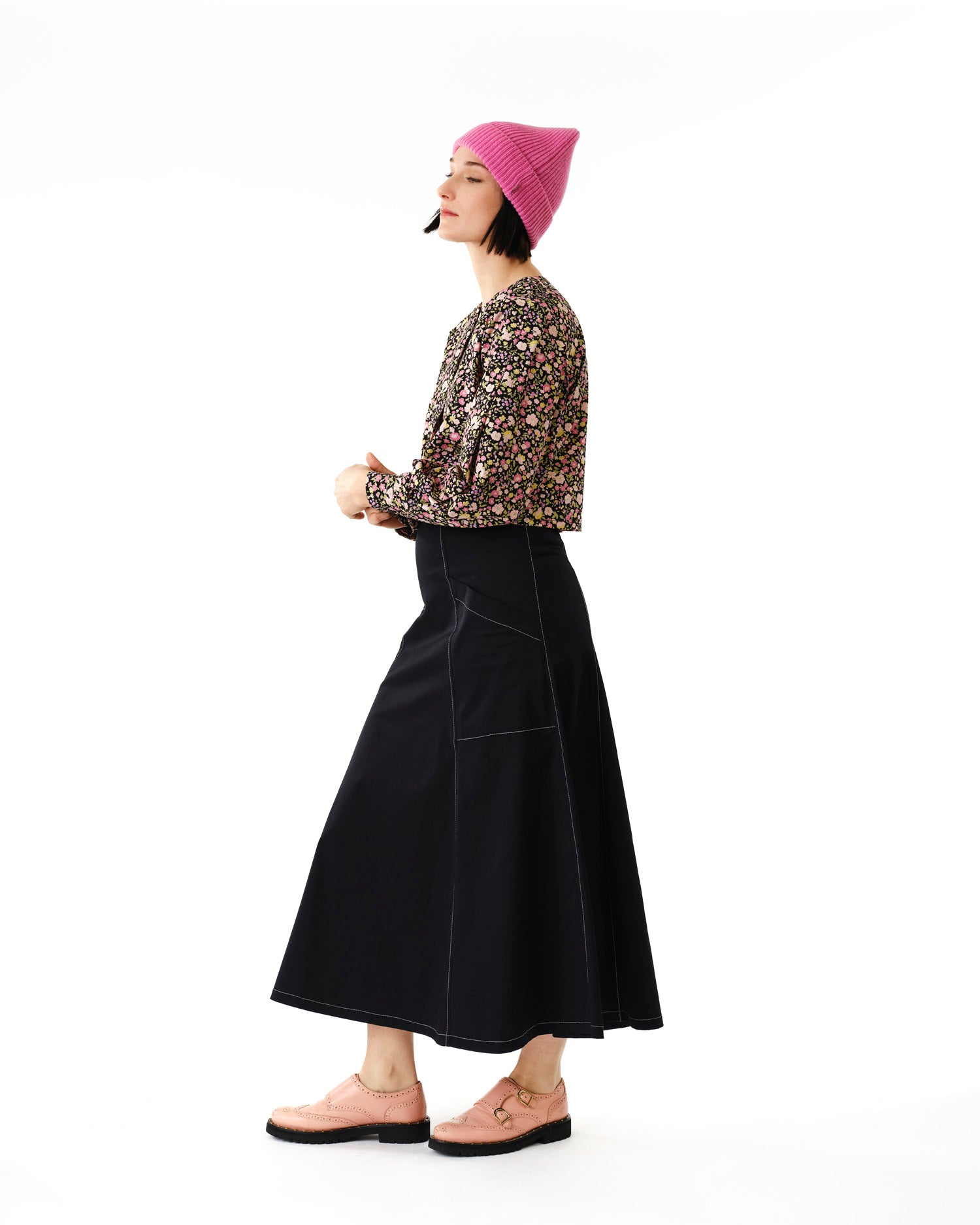 Jennifer Glasgow Design model in floral long sleeve blouse paired with black A line skirt and pink beanie in Kelowna