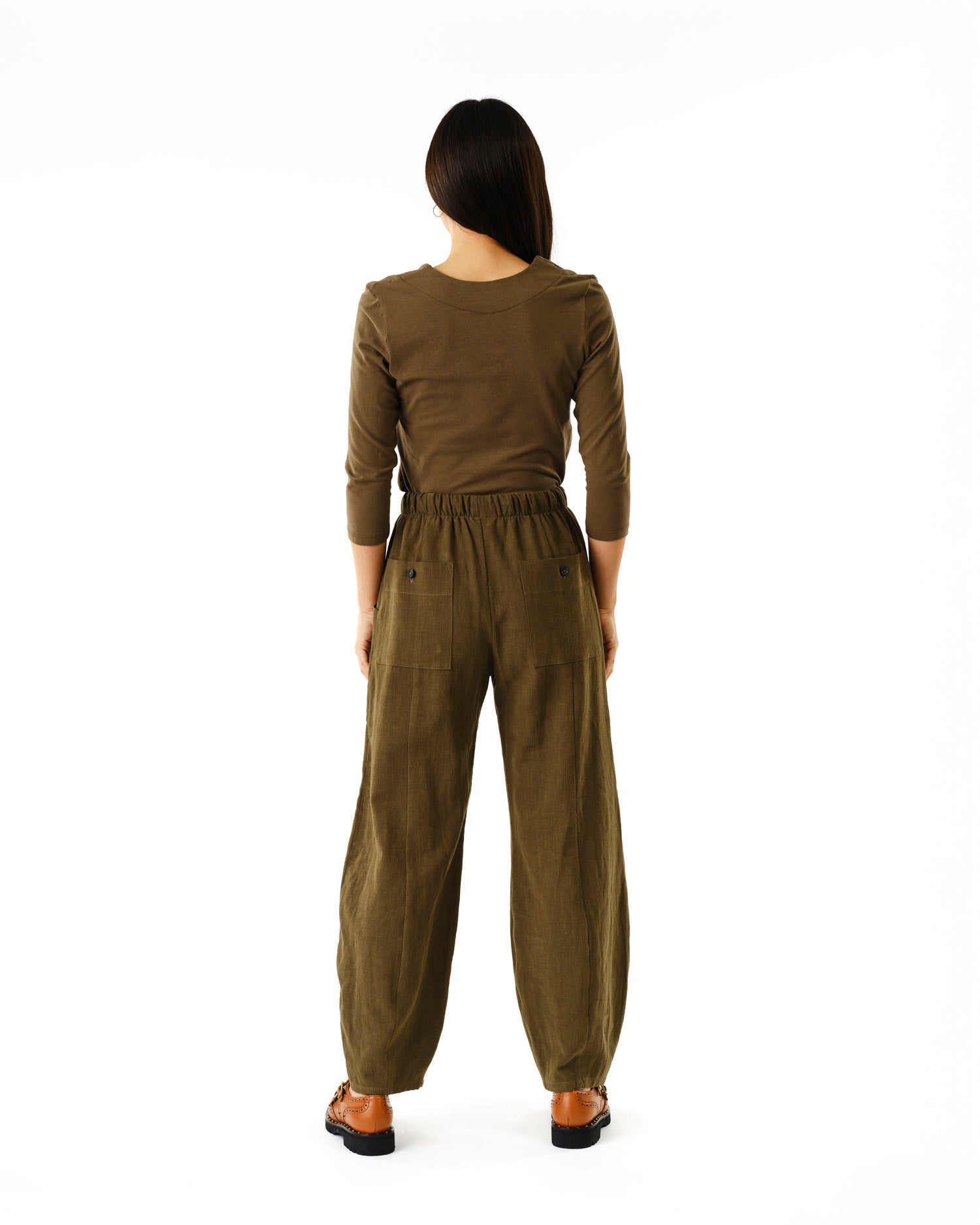 Jennifer Glasgow Design olive high waist wide leg pants with elastic waist and back pockets model back view in Kelowna