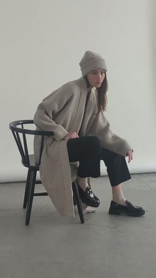 Video of woman seated in Bodybag by Jude Cambridge Cardigan in Sand
