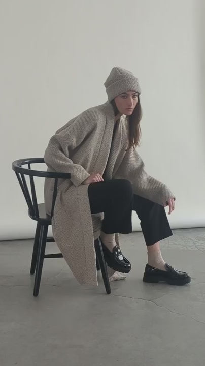 Video of woman seated in Bodybag by Jude Cambridge Cardigan in Sand