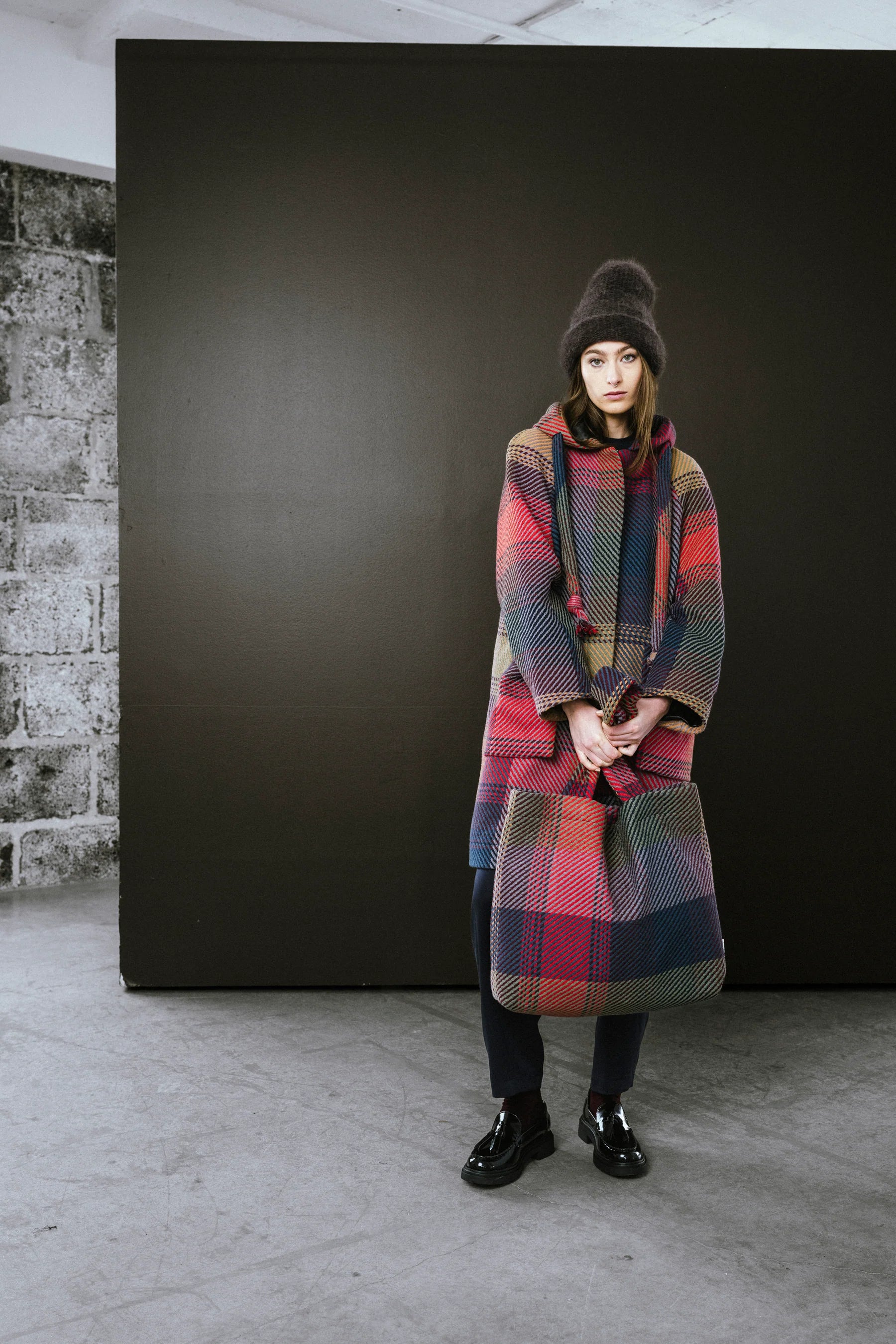 Stylish BodyBag by Jude tote bag displayed with a model in a colorful coat and hat in Kelowna
